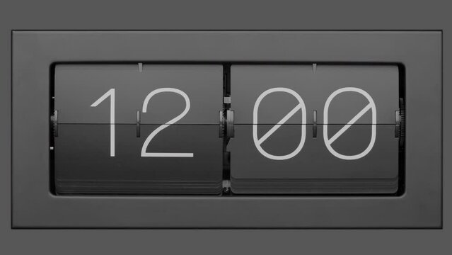 Flip clock quickly flips. .Retro flip clock changing from 11:59 to 12:00. Slow motion. Close up.