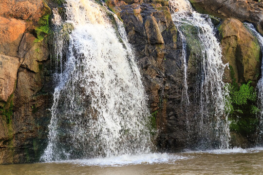 Beautiful Waterfalls in gir forest. waterfall mountain river in the dhari saurashtra in gujarat, with lush green tropical rainforest jungle. Wonderful freshwater rapids waterfalls river flowing