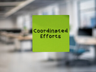 Post note on glass with 'Coordinated Efforts'.
