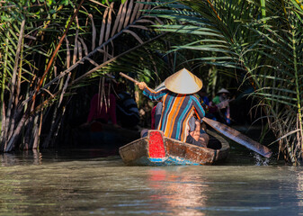 rowing a boat on a narrow river 