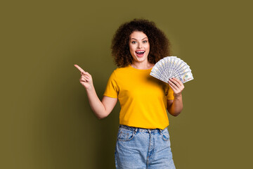 Photo of young woman in yellow t shirt direct finger novelty hold dollars shocked investment...