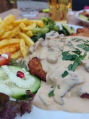 Savoring German Delicacy: Hunter's Schnitzel with Fries and Vegetables