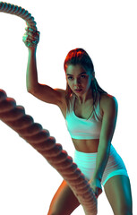 Ropes. Portrait of sportive woman workout, doing exercises with sports equipment isolated on transparent background in neon light. Sport, gym, action, motion, beauty concept. Fitness, hobby, health