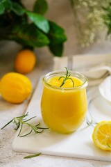 Homemade creamy Lemon curd served in a glass jar - Spring Easter dessert, selective focus