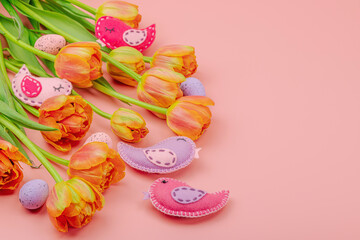 Gentle Easter composition with tulips flowers and handmade felt birds. Traditional elements