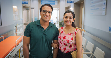 Portrait of Young Indian Couple in a Hospital Smiling and Looking at the Camera. Happy Male and...