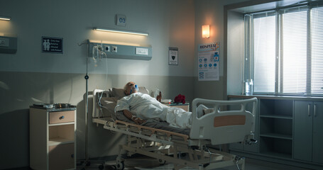 Hospital Ward: Portrait of Indian Elderly Man Wearing Oxygen Mask Sleeping in Bed, Recovering after...