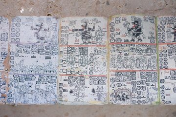 Mayan writing manuscript on square sheets of paper forming a whole story