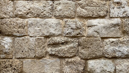 Textured Limestone Wall Close-Up With Varied Stone Sizes And Natural Patterns
