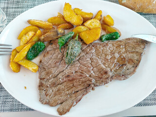 Grilled pork chop with potatoes.
