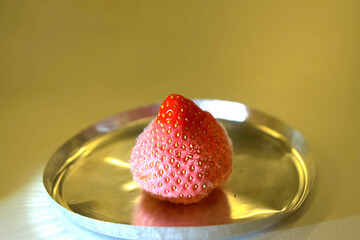 Frozen strawberries on iron cup.