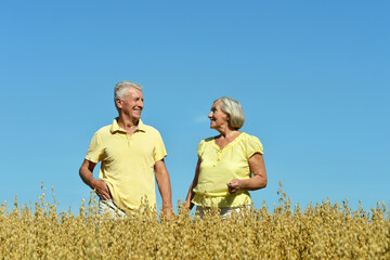 Loving mature couple in field at summer