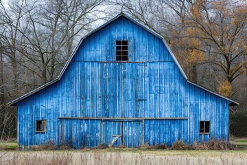 Vintage blue barn with a rustic appearance in a tranquil rural landscape
