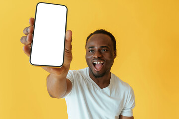 Empty display of smartphone, holding. Black man is in the studio against yellow background