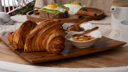 Austrian-style croissant together with Austrian butter and marmalade. Breakfast table with high nutritions vegan and vegetable food