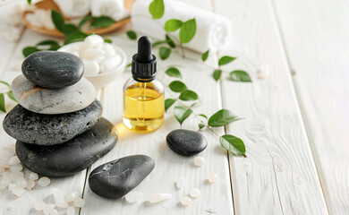Beautiful spa composition with stones and oil bottles on wooden background