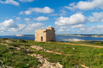 Fototapeta na wymiar Marfa Ridge, Mellieha, Malta - January 8th 2023: World War 2 era British army Pillbox on Marfa Ridge overlooking the Gozo Channel, Cirkewwa ferry terminal and Gozo and Comino Islands.