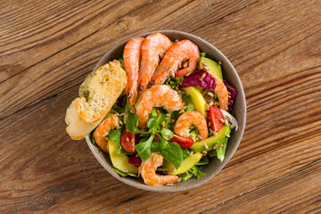 Spring salad with shrimp, mango and avocado. Served in a bowl, with croutons, sprinkled with roasted sunflower seeds. - 764770818