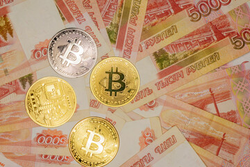 Bitcoin on banknotes with a face value of five thousand Russian rubles. The BTC cryptocurrency.