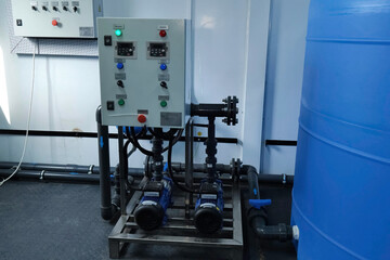 Pumps with induction motors on pipeline. Pump control panel.