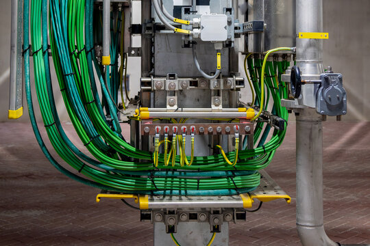 Picture of yellow colored electrical grounding cables and green signal cables in a industrial area, in use for signal transfer and to prevents hazard in electrical shortcut situations