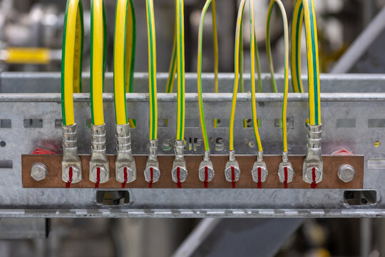 Picture of electrical grounding on a copper rail in a industrial area, it prevents hazard in electrical shortcut situations