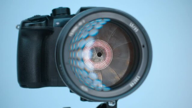 A professional camera on a tripod with an expensive lens with an aperture of 1.5 and a focal length of 85 mm, which reflects the ring LED light. Closeup. Macro. Shot in motion