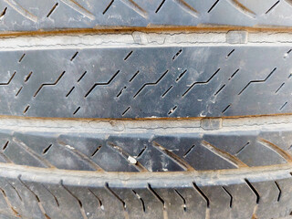 Close-up view of old black weathered tyre background