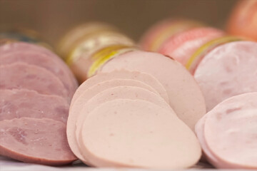 Slices of sausage of different varieties on table. Sausage assor