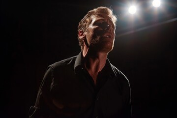 A theatrical actor delivering a powerful monologue on stage, standing in front of a spotlight with dramatic lighting creating strong shadows