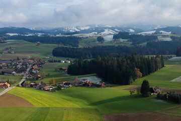Fototapeta na wymiar Swiss village, houses among hills.