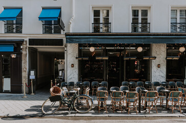 Cozy street with tables of cafe  in Paris, France. Cityscape of Paris. Architecture and landmarks of Paris - 764800053