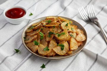 Homemade Roasted Garlic Parmesan Potatoes on a Plate, side view.