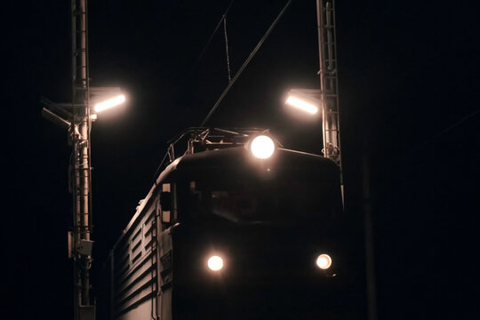 leading locomotive of the train in the night. A traveling train.