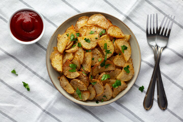 Homemade Roasted Garlic Parmesan Potatoes on a Plate, top view. - 764804015