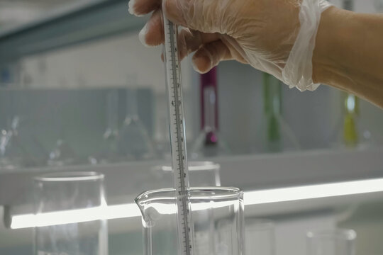 Thermometer in glass beaker. Laboratory tests