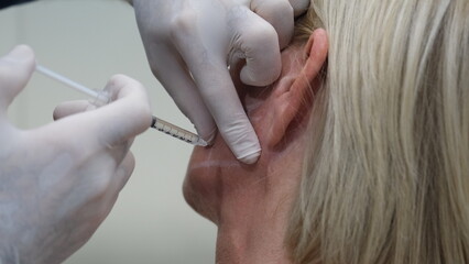 woman getting botox. close-up botox syringe and botox treatment