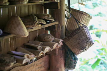 Selective focus bamboo woven accessories on shelves in a hill tribe house in Thailand. Bamboo in...