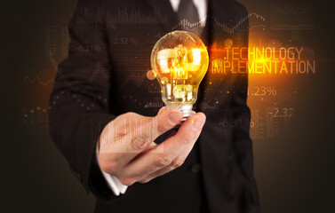 Businessman holding a lightbulb concept