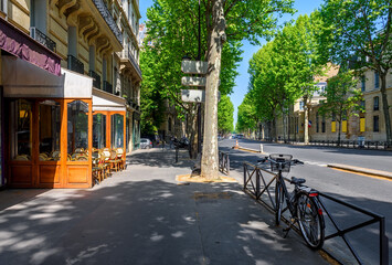 Cozy street with tables of cafe and bicycle in Paris, France. Cityscape of Paris. Architecture and landmarks of Paris - 764831037