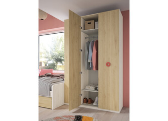 a room with a colorful wall and a bed with a painting on the wall.