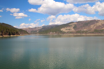 A body of water with hills in the background