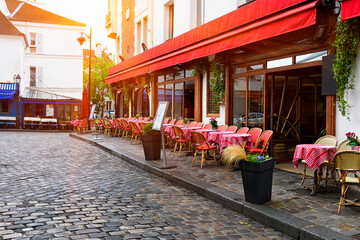 Cozy street with tables of cafe in quarter Montmartre in Paris, France. Architecture and landmarks of Paris. Postcard of Paris - 764835010