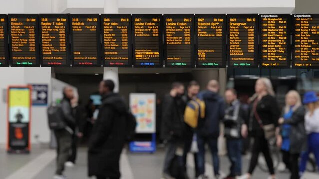 UK train station concourse.
Slow motion shot of the information boards and people on a railway station concourse. Shot at 50fps.
