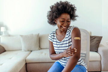Portrait, covid or vaccine and a black woman with a plaster on arm sitting in a hospital. Medical,...