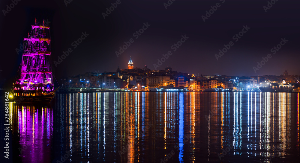 Sticker Galata Tower, Galata Bridge, Karakoy district and Golden Horn with pirate ship at night, istanbul - Turkey