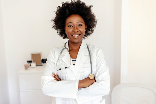 Portrait of black woman doctor with smile, mockup and confidence, leader in African medicine and treatment. Happy medical professional, trust and help, professional healthcare consultant in hospital.