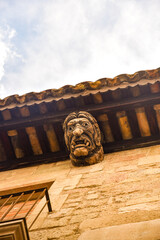 ancient ornamental face wood carving in an old building in Solsona, catalonia, Spain