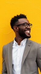 An executive wearing a warm smile conveying approachability on a cheerful yellow background.