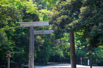 wood bridge and Tori gate at The Grand Shrine of Ise or Ise Jingu Naiku, Inner Sanctuary in the natural green scenery background, Ise City, Mie., Japan